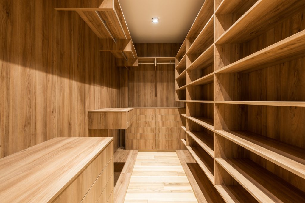 Modern wardrobe interior with shelves at home